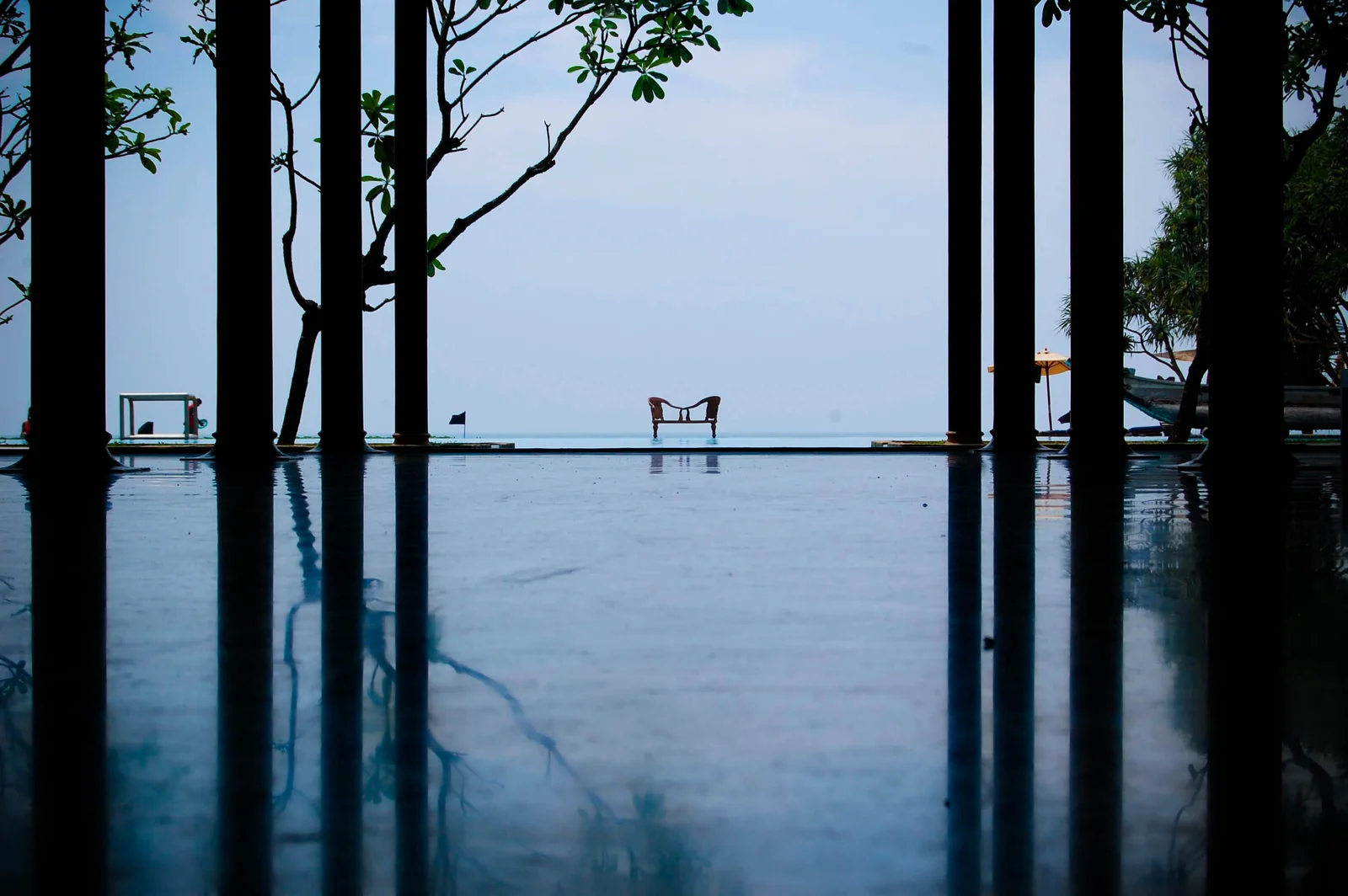 Open-sided lobby and reflective infinity pool at Heritance Ahungalla looking towards the Indian Ocean.