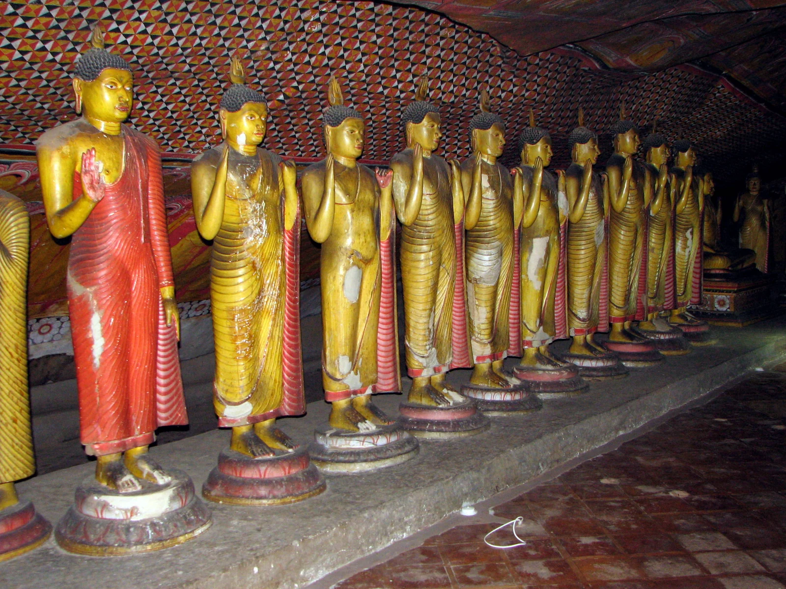 Buddha statues and painted walls inside Dambulla cave temple, Sri Lanka